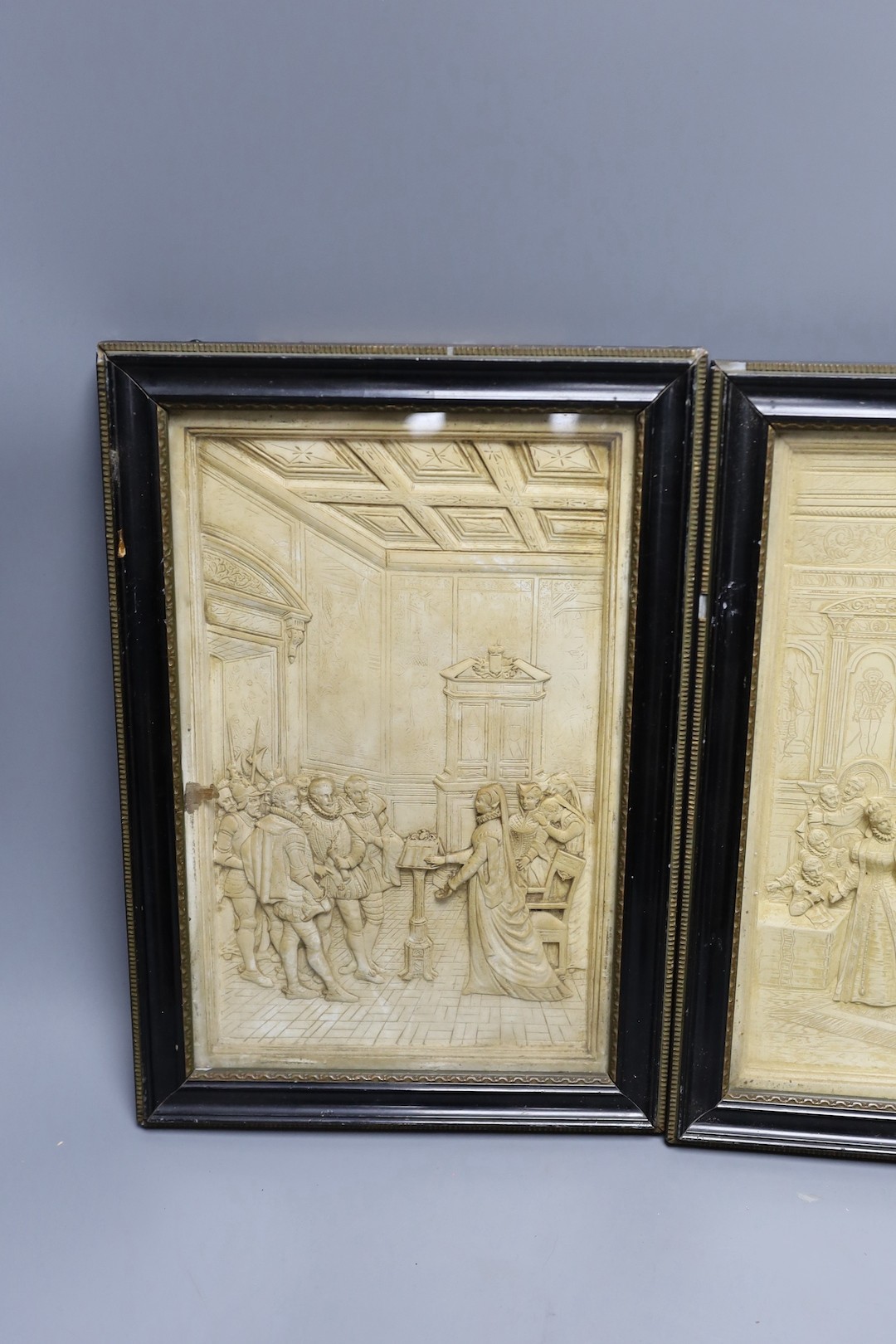 A pair of plaster relief panels of the court of Elizabeth I in glazed wooden frames - 30 x 19cm